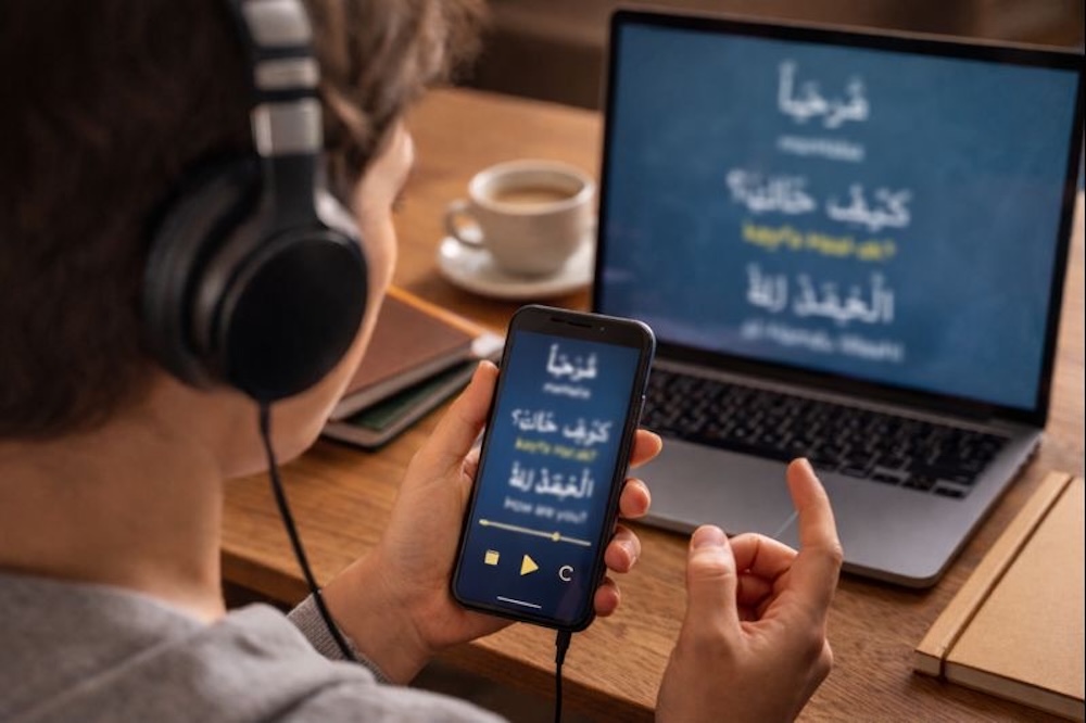 English speaker learning spoken Arabic using audio and headphones